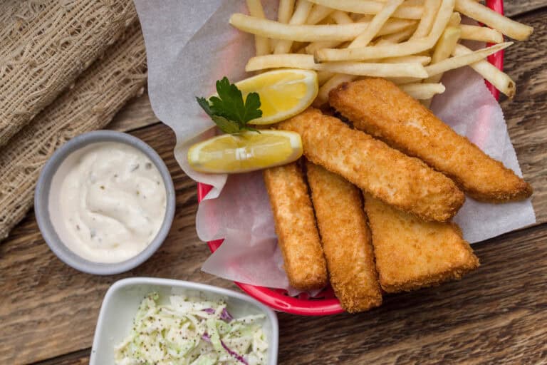 fish dinner with french fries, cole slaw, and tar tar sauce